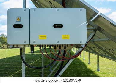 Estonia - 09.19.2020: Huawei Generator Under Solar Panel On A Green Grass Field