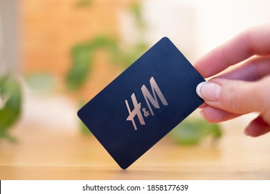 Estonia - 11.14.2020: Black H and M gift card with golden letters. H&M or Hennes & Mauritz prepaid card. Shopping and payment.
