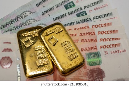 Estonia - 5.7.2021: Russian rubles banknotes with gold bullion bar. Gold backed financial system of Russia. Russian gold reserves. De-dollarization. World monetary system.