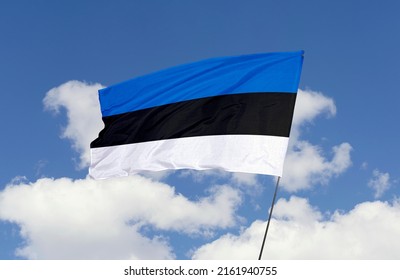 Estonia flag is isolated on the blue sky with a clipping path. flag symbols of Estonia.