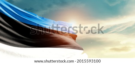 Estonia national flag waving in beautiful sky.