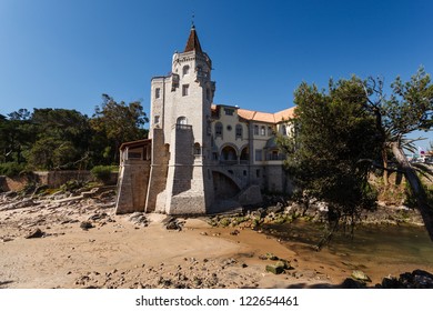 Estoril, Portugal beach with beautiful building with turret and castle tower