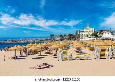 ESTORIL, PORTUGAL - JUNE 21, 2016: Umbrellas on public beach in Estoril in a beautiful summer day, Portugal on June 21, 2016