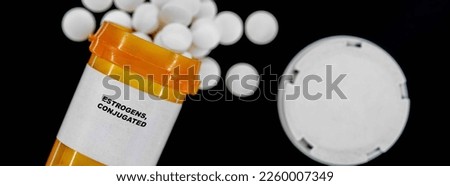 Estrogens, Conjugated Rx medical pills in plactic Bottle with tablets. Pills spilling out from yellow container. ストックフォト © 