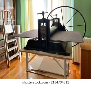 Etching press for printmaking Art equipment in studio. Ancient engraving old machine. Space for text. Linocut, woodcut, etching, monotype, print, embossing, stamp art printing step process hand made
				
				