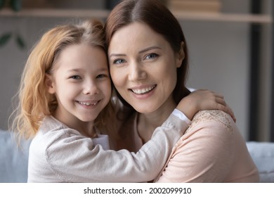 Eternal Value. Headshot Portrait Of Happy Step Mother Custodian Hold Little Foster Kid Preteen Daughter In Warm Kind Embrace At Adoption Day. Two Smiling Sisters Adult Elder And Younger Look At Camera