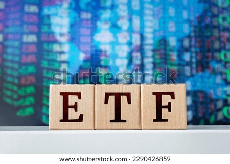 ETF - acronym from wooden cubes with letters, Exchange-traded fund. Stock market trading investment financial concept.