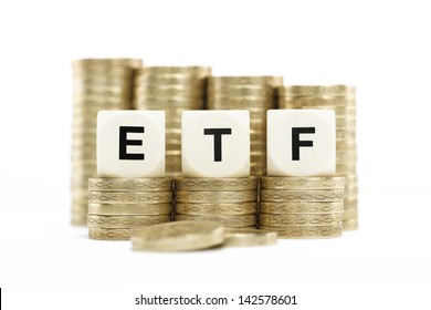 ETF (Exchange Traded Fund) On Stacks Of Gold Coins With A White Background