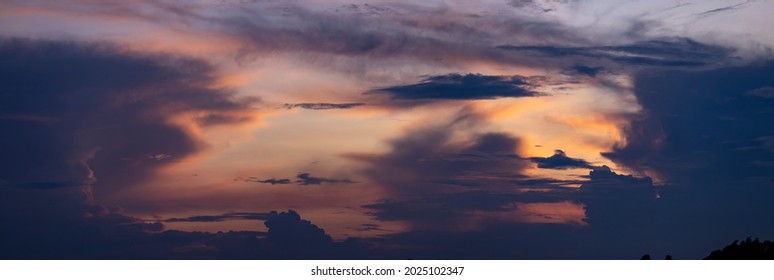 Ethereal panorama of painterly colorful cloudscape decor with radiant vibrant colorful magenta, yellow and orange sunset colors. Weather conditions and climate concept. Abstract background wallpaper.