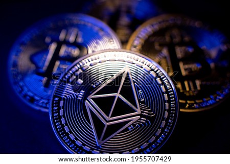 Ethereum Coin and Bitcoin in background. Cryptocurrency ETH and BTC. Tokens Blockchain. High Tech Crypto concept. Decentralized crypto currency Ether