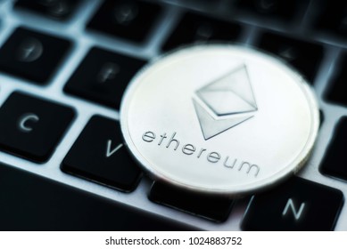 Ethereum coin isolated on keyboard. Crypto currency - Ethereum background