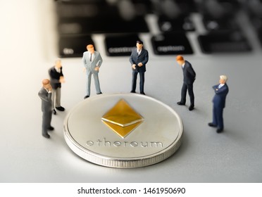 Ethereum (ETH) Coin And Businessmans On Notebook. Digital Cyber Safety Or Security Encryption. Manage Bitcoin Price Schedule Concept. Money Laundering Bitcoin Concept. Market Manipulation.