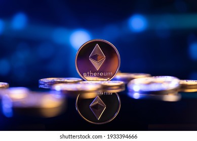 Ethereum (ETH) cryptocurrency coin in front of an abstract blue virtual background