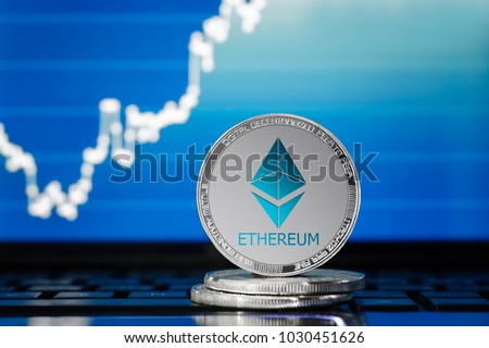 ETHEREUM (ETH) cryptocurrency; silver ethereum coin on the background of the chart
