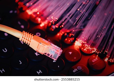 Ethernet cable on computer keyboard. Fast internet concept with optical fiber