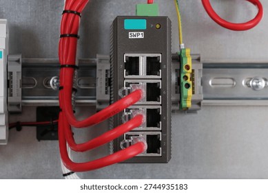 Ethernet data switch with connected patchcords with Rj45 connectors, installed in the electrical switchboard. 