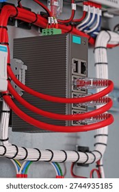 Ethernet data switch with connected patchcords with Rj45 connectors, installed in the electrical switchboard. 
