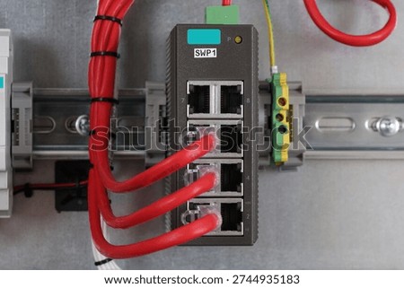 Ethernet data switch with connected patchcords with Rj45 connectors, installed in the electrical switchboard. 