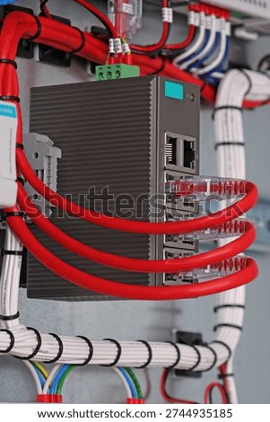 Ethernet data switch with connected patchcords with Rj45 connectors, installed in the electrical switchboard. 