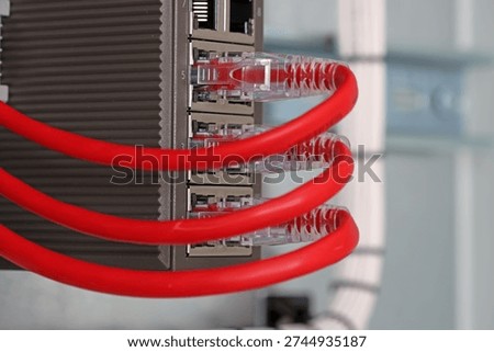 Ethernet data switch with connected patchcords with Rj45 connectors, installed in the electrical switchboard. 