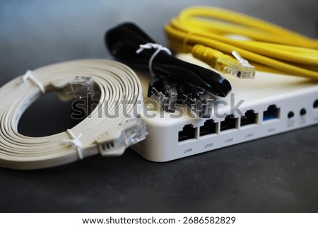 Ethernet Network Cables and Router on Black Surface for Home Connectivity Solutions