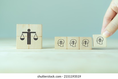 Ethical corporate culture concept. Ethics inside human mind. Business integrity and moral. Putting wooden cubes with ethics inside a head standing with  ethical corporate. Sustainable business. - Shutterstock ID 2151193519