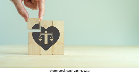 Ethical corporate culture concept. Ethics inside human heart. Business integrity and moral. Placing wooden cubes with ethics inside a heart on smart background. Sustainable business development.