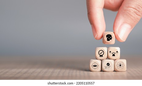 Ethics inside human mind, Business ethics concept. Hand hold ethics inside a head symbols in wooden cubes stacked on gray background with copy space. - Shutterstock ID 2205110557