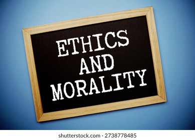 Ethics And Morality text written on chalkboard flat lay on blue background