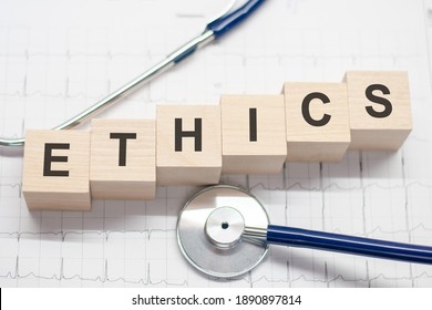 Ethics Word Written On Wooden Blocks And Stethoscope On Light Background. Healthcare Conceptual For Hospital, Clinic And Medical Busines.