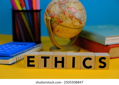 Ethics words on wooden blocks with letters, globe, stationeries, books and calculator on yellow background. ethics moral philosophy concept, business and management concept - Powered by Shutterstock