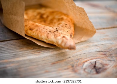 Ethnic Bread In A Paper Bag On A Wooden Table. Pita. Cake. Ecological Food.