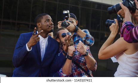 Ethnic Celebrity Man Giving Autographs To People On Red Carpet And Makes Photos