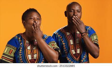 Ethnic couple blowing air kisses in front of camera, doing romantic flirty gesture in studio and sharing love. African american married people sending kiss to someone, affection symbol. - Powered by Shutterstock