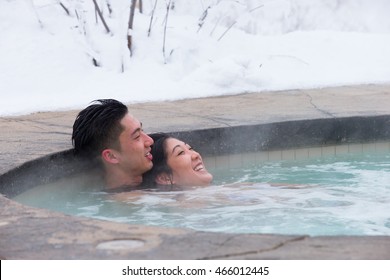 An Ethnic Couple Visits An Outdoor Spa During Canadian Winter