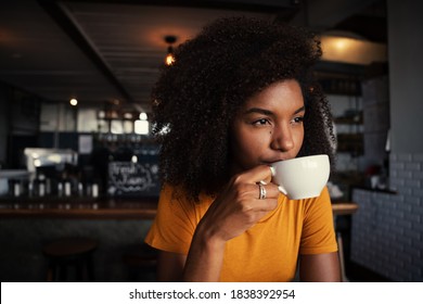 Ethnic Female Sipping Hot Coffee Relaxing In Rustic Restaurant 