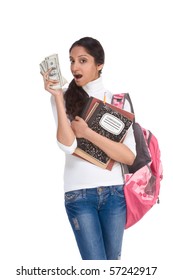 Ethnic Indian College Student With Compositions Notebook, Copybooks And Backpack Holds Pile 100 (one Hundred) Dollar Bills Happy Getting Money Help To Subsidies Costly University Cost