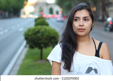 Ethnic woman daydreaming on the street 