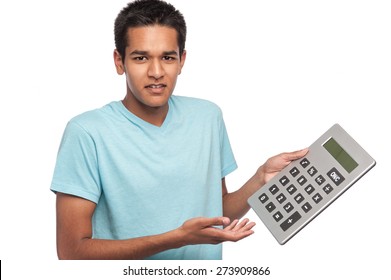 Ethnic young man with puzzled look and a big calculator. Studio shot on white background
