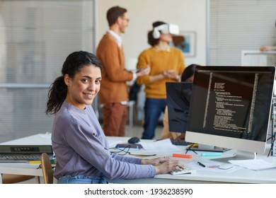 Ethnic Young Woman Programming Software In Office