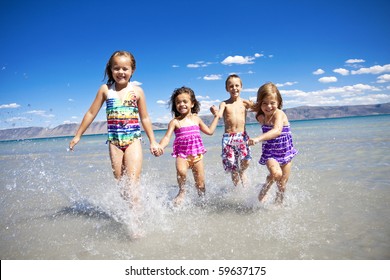 Ethnically Diverse Children Playing At The Beach