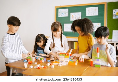 Ethnicity diversity group of Elementary school playing with colorful blocks on table in classroom. Education brain training development for children skill, International school education concept - Powered by Shutterstock