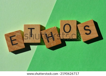 Ethos, word in wooden alphabet letters isolated on green background