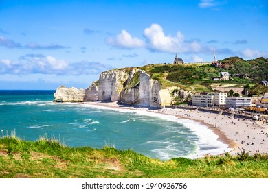 Etretat Aval cliff, rocks and natural arch landmark and blue ocean. Normandy, France, Europe. Beatiful summer panorama. - Shutterstock ID 1940926756