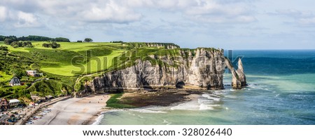 Etretat Aval cliff, rocks and natural arch landmark and blue ocean. Aerial view. Normandy, France, Europe.