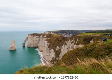 Etretat, Seine-Maritime, Normandie / France - OCTOBER 14, 2018: Etretat is best known for its chalk cliffs, which include natural arches, monolithic formations and its rocky beach.