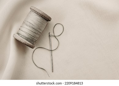 etro needle and thread lie on the fabric. Tools for a tailor or seamstress. Black and white photography - Powered by Shutterstock