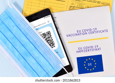 EU COVID-19 Vaccination Certificate On Paper And Digital On Mobile Phone, Vaccine Passport And Face Mask