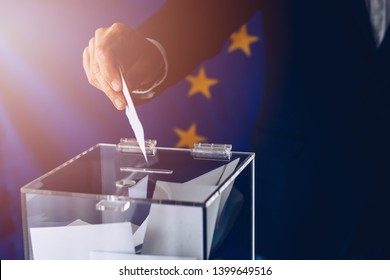 EU Elections. Man Throwing His Vote Into The Ballot Box. Elections To The European Parliament