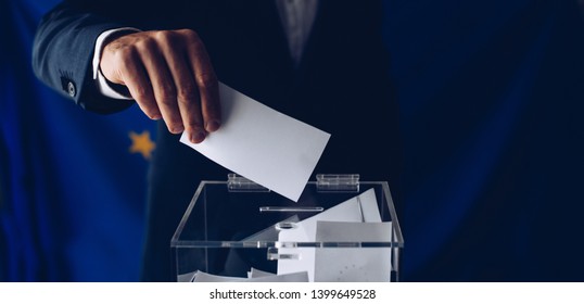 EU Elections. Man Throwing His Vote Into The Ballot Box. Elections To The European Parliament